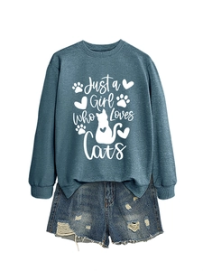 Detail of blue crewneck sweatshirt with Just a Girl Who Loves Cats text and feline graphics