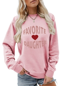 Close-up of pink crewneck sweatshirt with 'FAVORITE DAUGHTER' text and red heart graphic