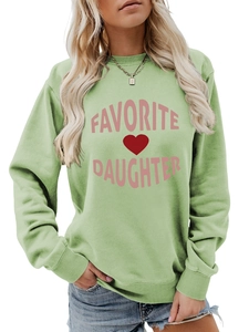 Detail of green crewneck sweatshirt with pink Favorite Daughter text and red heart print