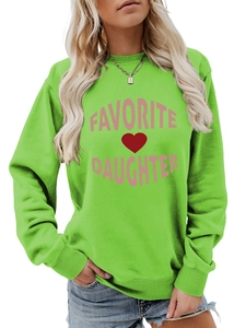 Close-up of ribbed cuffs and hem on the grass green cotton blend sweatshirt