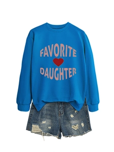 Flat lay of blue sweatshirt with Favorite Daughter text and distressed denim shorts
