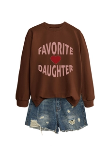 Detail of Favorite Daughter brown sweatshirt paired with distressed blue denim shorts