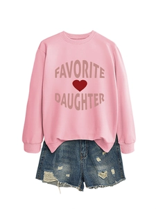 Flat lay of pink sweatshirt with Favorite Daughter print and distressed denim shorts