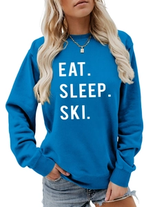 Detail of Eat Sleep Ski lettering on high-quality blue crewneck sweatshirt fabric