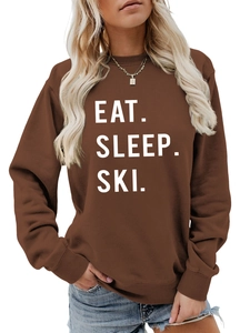 Close-up of the Eat Sleep Ski bold white print on a brown long-sleeve sweatshirt