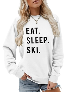 Detail of Eat Sleep Ski black print on a white long sleeve round neck sweatshirt