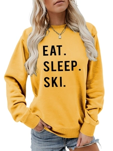 Detail of yellow sweatshirt with ribbed cuffs and Eat Sleep Ski slogan print