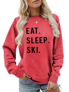 Detailed shot of red sweatshirt with black Eat Sleep Ski slogan and ribbed cuff details