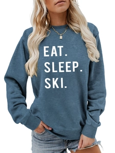 Detail of Eat Sleep Ski white typography on gray-blue long sleeve pullover sweatshirt