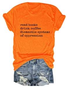 Flat lay of an orange cotton T-shirt with black text print and denim shorts