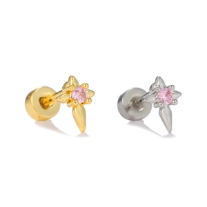 Close-up of gold and silver star helix piercings with pink cubic zirconia stones