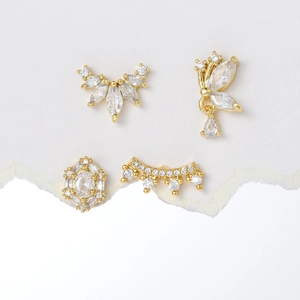Set of four gold stainless steel ear studs with butterfly wings and crown zircon designs