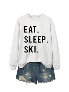 Close-up of Eat Sleep Ski grey sweatshirt and blue distressed denim shorts set