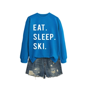Royal blue 'EAT SLEEP SKI' sweatshirt paired with distressed denim shorts for women