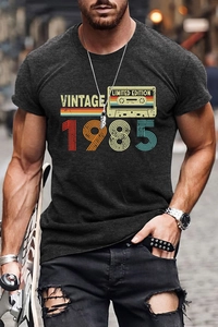 Macro shot of charcoal grey t-shirt featuring vintage 1985 tape print and soft cotton texture