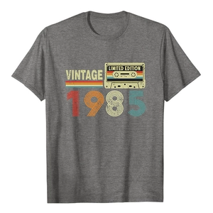 Detail of vintage 1985 graphic print on a gray cotton t-shirt with retro tape design