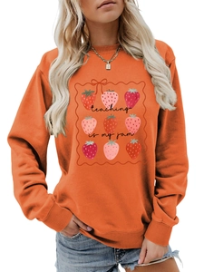 Detail of orange sweatshirt showing strawberry print and teaching is my jam text