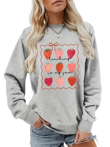 Detail of teaching is my jam slogan and strawberry graphic on grey sweatshirt