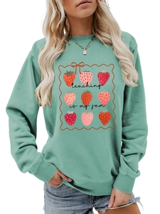 Detail of mint green sweatshirt with Teaching is my jam text and strawberry graphics