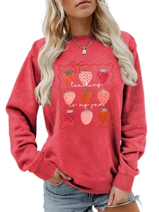 Detail of red crewneck sweatshirt with strawberry print and Teaching Is My Jam text