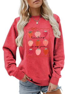 Close-up of strawberry print and 'teaching is my jam' text on red cotton sweatshirt