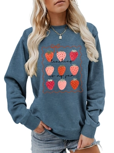 Detailed view of the strawberry print and teaching is my jam text on blue sweatshirt