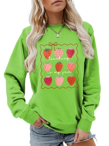 Detail of green crewneck sweatshirt with Teaching Is My Jam strawberry graphic