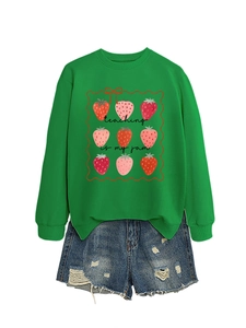 Detail of green strawberry sweatshirt with teaching is my jam slogan and denim shorts