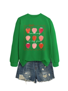 Detail of green sweatshirt with Teaching Is My Jam text and strawberry grid print