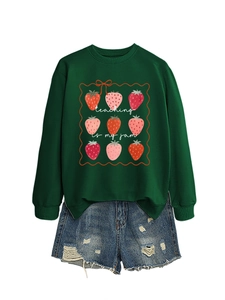 Close-up of strawberry graphics and teaching is my jam text on dark green sweatshirt