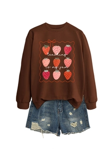 Detail of strawberry print sweatshirt with Teaching Is My Jam slogan and denim shorts