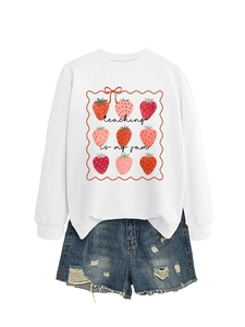 Close-up of strawberry print and teaching is my jam lettering on white sweatshirt