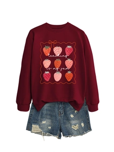 Flat lay of maroon strawberry sweatshirt with blue distressed denim shorts set