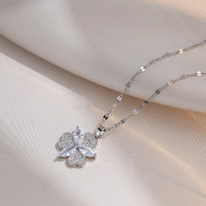 Elegant silver clover necklace with marquise zircon stones on silk fabric