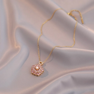 Rotating pink flower pendant with freshwater pearl on a delicate gold O-chain necklace