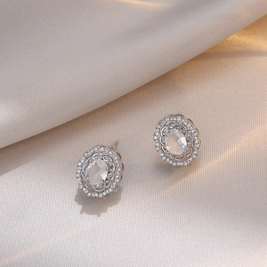 Elegant vintage S925 silver stud earrings with oval zircon and floral halo on satin