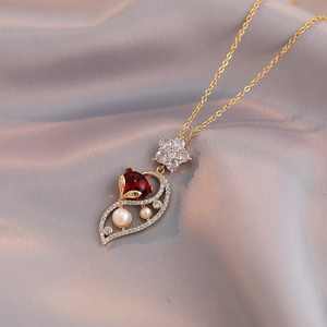 Elegant gold fox pendant necklace with red stone, zirconia flower and freshwater pearls