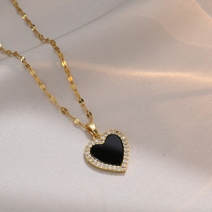 Minimalist heart pendant necklace with black enamel and zircons on a gold link chain