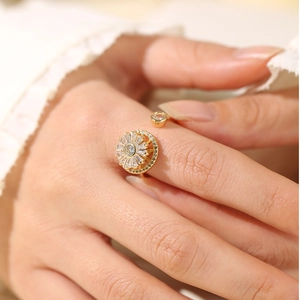 Detailed close-up of a rotating sunflower gold ring with sparkling cubic zirconia inlay