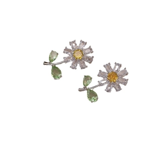 Daisy flower stud earrings with yellow and green zircons on a polished silver base