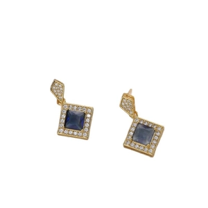 Minimalist geometric gold earrings with square blue zircon and white diamonds on white background