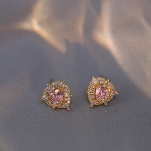 Pink heart-shaped zircon earrings with gold plating on grey satin background