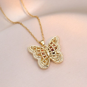 Gold butterfly pendant necklace featuring hollow mesh wings and zircon inlay