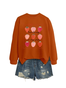 Detail of teaching is my jam sweatshirt with strawberry print and distressed denim shorts