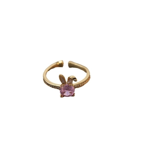 Adjustable golden ring featuring pink zircon stone and rabbit ear design on white background