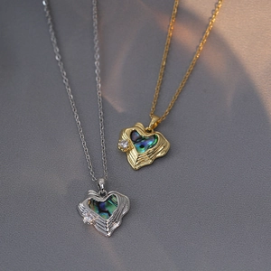 Elegant heart pendant necklace featuring iridescent abalone shell and sparkling zircon inlay