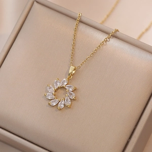 Golden titanium steel necklace featuring a flower-shaped zircon pendant on a velvet box