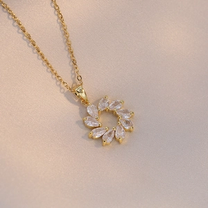 Golden titanium steel sunflower necklace featuring teardrop cubic zirconia wreath pendant