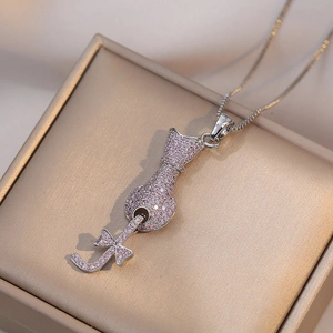 Cat pendant necklace with pink zircons on a gold jewelry gift box, chic silver finish