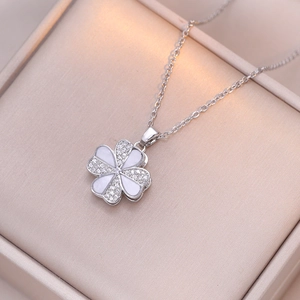 Elegant rotating four-leaf clover necklace with cubic zirconia and white enamel pendant